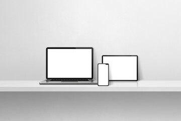 Laptop, mobile phone and digital tablet pc on white concrete wall shelf. Horizontal background