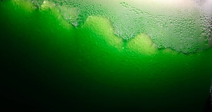 Ice cold sorbet machine mixing fruit juice. Freezing slush spinning around, summer treat. Crushed iced coloured with fruit flavor sweeteners 