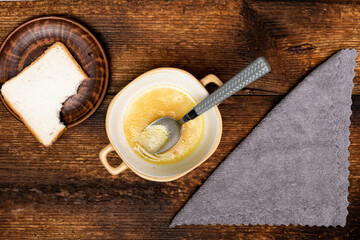 Started eating chicken with spaghetti, carrots, potatoes. Dark wooden background. Top view.