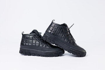 Men's leather short boots on a white background. Winter boots collection 2022