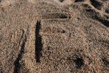 English alphabet. Sand on the beach. The letter E