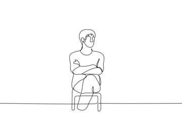 man sits with his legs and arms crossed and looks somewhere - one line drawing vector. closed pose concept, non-contact person, waiting, viewer or listener
