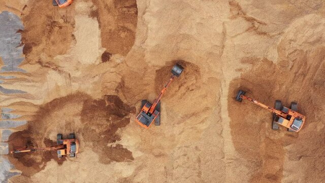 Construction site, Aerial top view road roller and loader excavator tractor and soil grade car earthmoving at work, Heavy equipment is grading the land, moving and flattening out red clay soil.