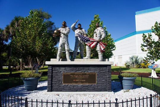 Kennedy Space Center, Florida, USA: Bronze statue of Apollo 11 astronauts and Moon Tree Garden at Apollo and Saturn V Center. Neil Armstrong, Edwin 'Buzz' Aldrin, and Michael Collins. 