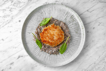 Seafood soup with salmon in a festive plate on a marble background. Restaurant banquet menu.