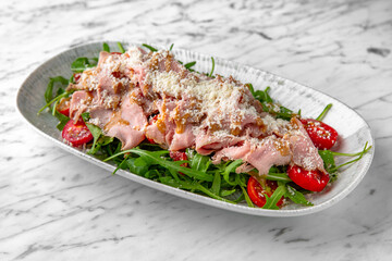 Spaghetti with shrimps in a festive plate on a marble background. Restaurant banquet menu.