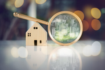 Magnifying glass with line of building and house model at on the glass table with building...