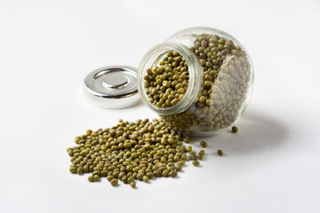 Cereal mash in a glass jar. Green grain beans mash on a white background for insulation