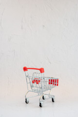 Empty shopping trolley in silver and red
