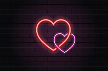 Red and pink neon heart for valentines day on black brickwall background