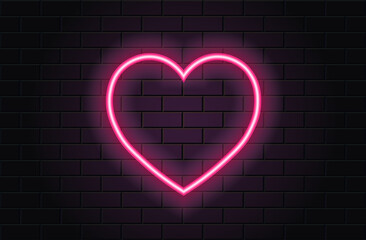 Pink neon heart for valentines day on black brickwall background