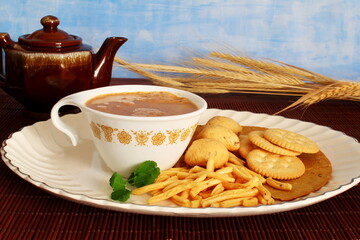 tea cup with traditional homemade indian gujarati tea time snack food