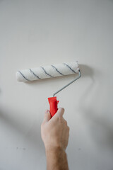 painting a wall with roller