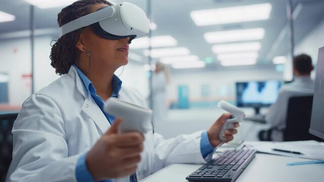 Futuristic Medical Hospital: Black Female Neurosurgeon Wearing Virtual Reality Headset Uses Controllers to Remotely Operate Patient Using Medical Robot. High-Tech Treatment of Neurological Disease