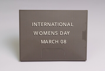 International Women's Day holiday inscription on gray chalkboard, white background