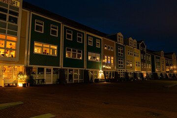 colorful row houses made of wood in the netherlands at the blue hour