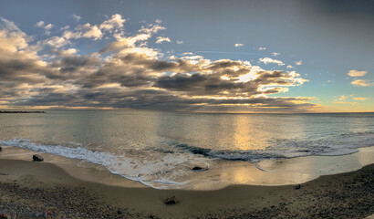 rays of light at sunrise on a beach of the Mediterranean Sea