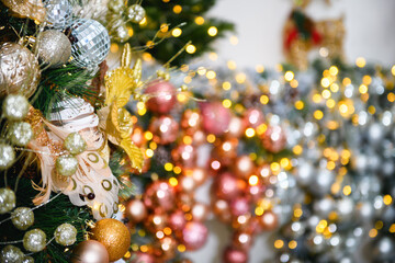 New Year's or Christmas interior: toys on christmas tree with blurred background. Christmas tree decoration
