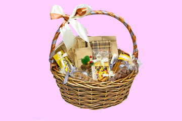 Big Christmas basket full of luxury products isolated on pink background