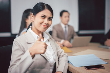 Asian businesswoman giving thumbs up