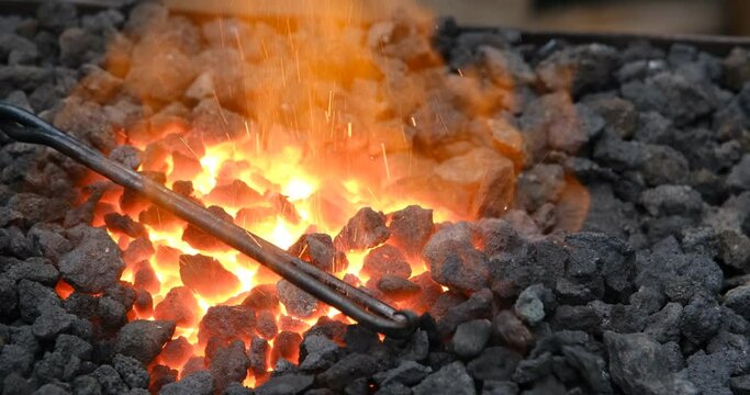 Conceptual image of a hot iron in burning coals. Forge fire Forge fire used for creating iron tools in blacksmith's.