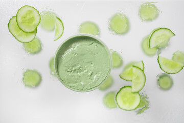 Handmade organic bio nature cosmetics with cucumber ingredients on gray background. Natural beauty and spa concept. Space for text
