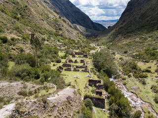 Aerial view of landscapes of Chupani village in middle of the Peruvian Andes. Small community in the Sacred Valley with some ruins and river.
