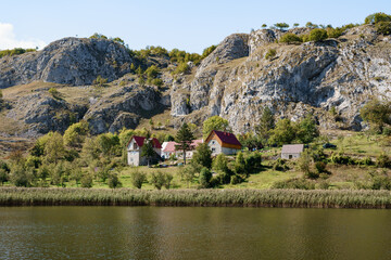 Fototapeta na wymiar Houses at the foot of the mountains near the lake. Montenegro, north