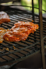 Steak cooking over flaming grill
