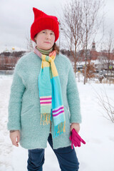 A girl in bright and funny clothes walks in the winter park Zaryadye, Moscow. Hiking, rest