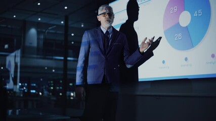 Hospital Conference Meeting Room: Senior Male Physician Holds Tablet Computer and Talks to Team of Medical Doctors Discuss Patient Treatment. Research Scientists Talk of Drug, Medicine Development - Powered by Adobe