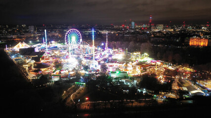 Aerial drone night shot of illuminated Winter amusement park at Hyde Park as seen at Christmas...