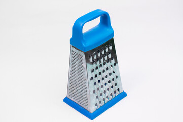 blue grater for rubbing products on a white background. Cooking concept. Vegetable chopper