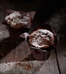 Chocolate muffins on a wooden table