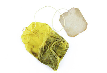 Used tea bag with blank label attached isolated on white background