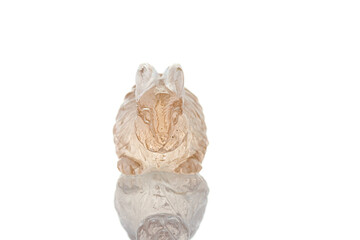 beautiful figurine of a hare made of topaz on a white background