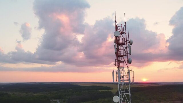 Telecommunication tower 5G Antenna, cell phone tower with base station transceiver at sunset. Connection system of communication systems in countryside.