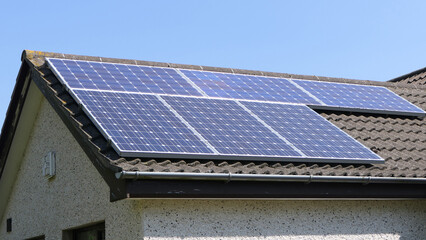 Solar panels on roof of a home generating renewable electric energy