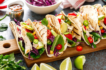 Fototapeta Chicken tacos with grilled meat, avocado, fresh vegetable salad and sauce salsa obraz