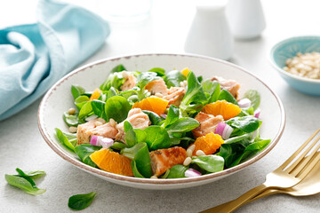 Christmas salmon orange salad with pine nuts, red onion and corn salad lettuce