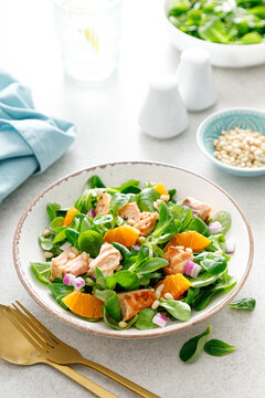 Christmas salmon orange salad with pine nuts, red onion and corn salad lettuce