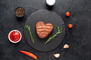 Heart shaped grilled beef steak for valentine's day on stone background