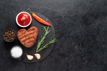 Heart shaped grilled beef steak for valentine's day on stone background with copy space for your text