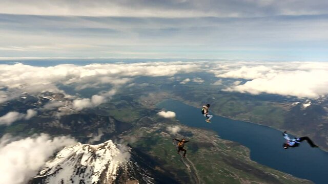 Sky divers exit aircraft to group free fall