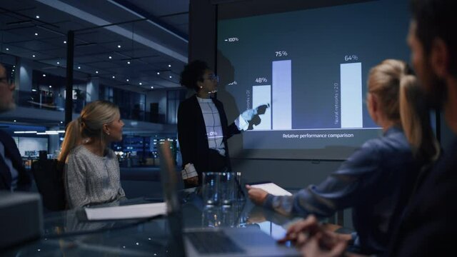 e-Business Technology Conference Presentation: Innovative Black Tech Engineer Talks about Revolutionary High-Tech Product. Projector Screen Shows Graphs, Infographics, AI, Big Data, Machine Learning