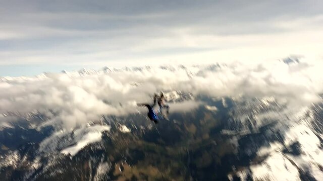 Sky divers exit aircraft to group free fall