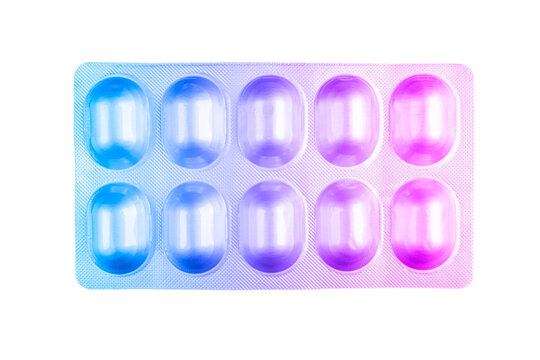 Macro shot pile of tablets pill in blister packaging isolated on white background. Blister pack in blur and pink tones. Pharmacy products. Medicine pills and drug. Health care. Pills background