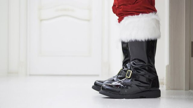4K - Santa Claus in the house. Santa Claus boots and sack with gifts
