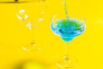 Bartender pouring Blue Lagoon  curacao syrup mixed with vodka and lemonade cocktail
