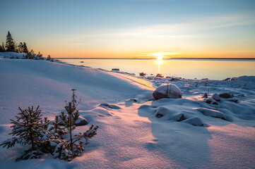 Panoramic sunset through the horizon. Winter wonderland scenery in scenic golden evening light at sunset with clouds